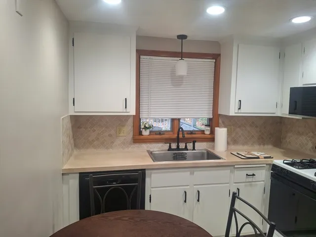 a kitchen with a sink cabinets and appliances