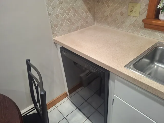 a white toilet sitting next to a bath tub