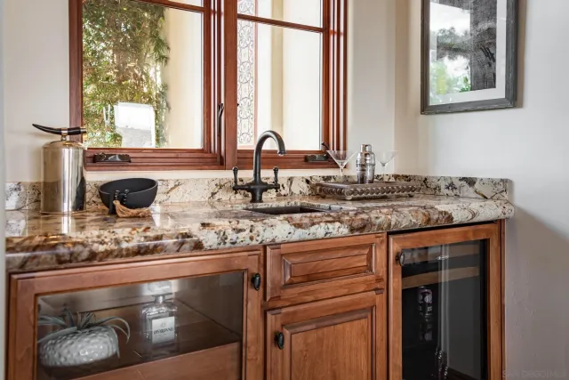 a bathroom with a granite countertop sink and a window