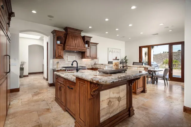 a kitchen with stainless steel appliances granite countertop a stove and a sink