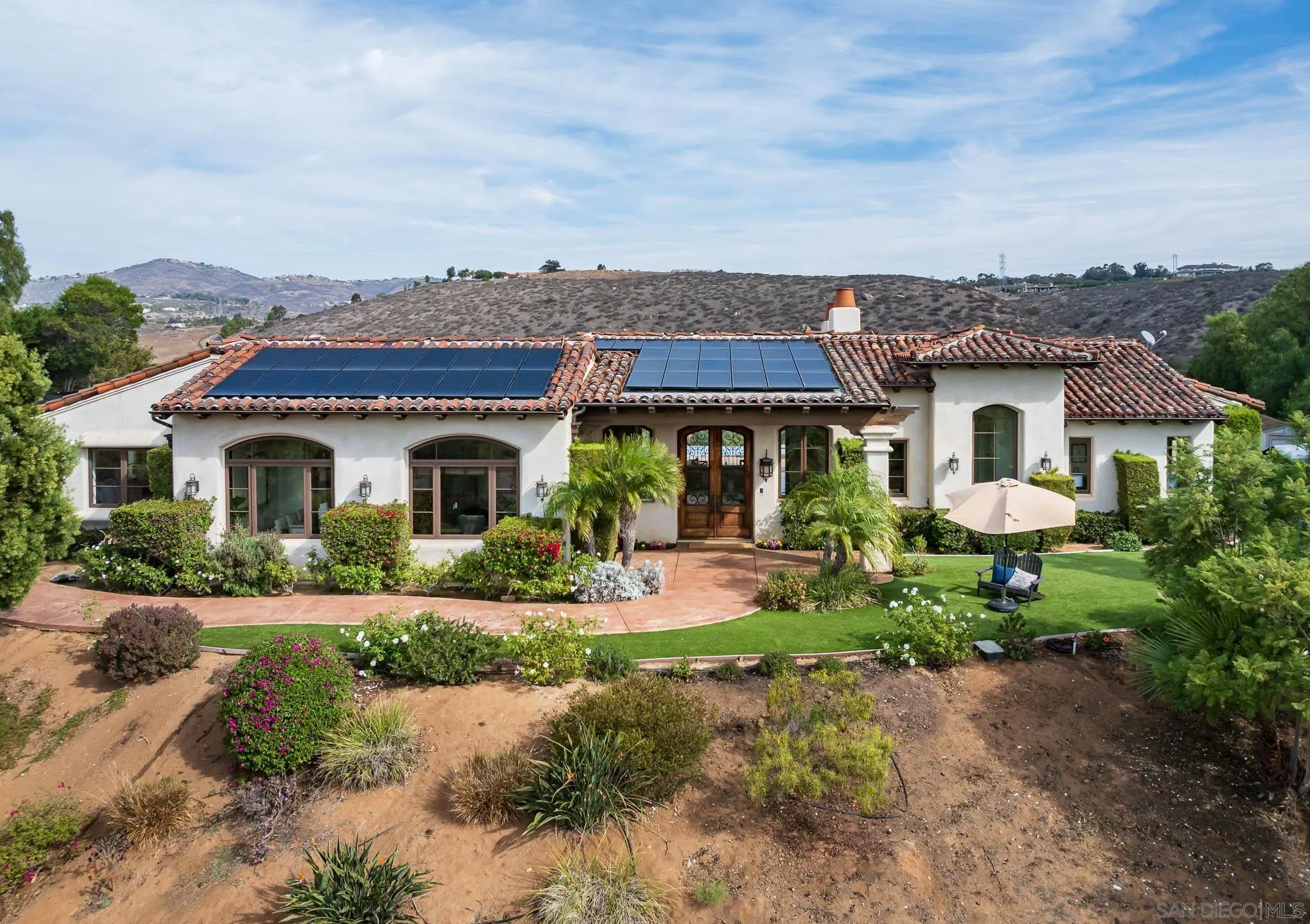 16531 Zumaque Street Rancho Santa Fe, CA 92067 - Photo 2 of 48 a front view of a house with garden