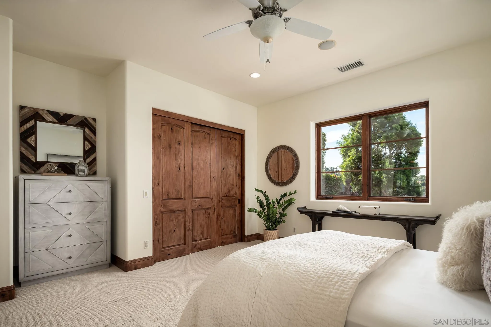 16531 Zumaque Street Rancho Santa Fe, CA 92067 - Photo 27 of 48 a bedroom with a bed a dresser and chair