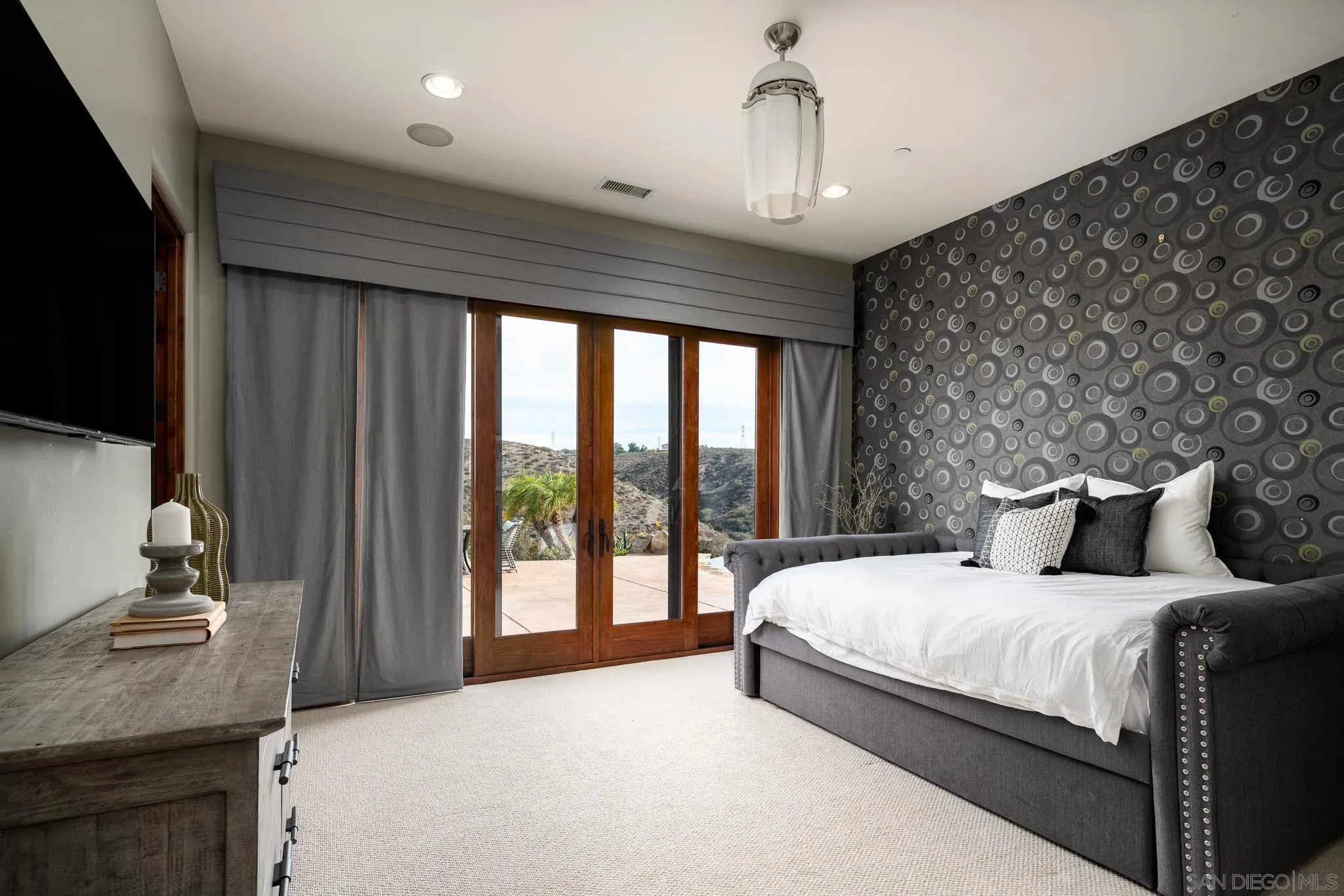 16531 Zumaque Street Rancho Santa Fe, CA 92067 - Photo 30 of 48 a bedroom with a large bed and a flat tv screen on dresser