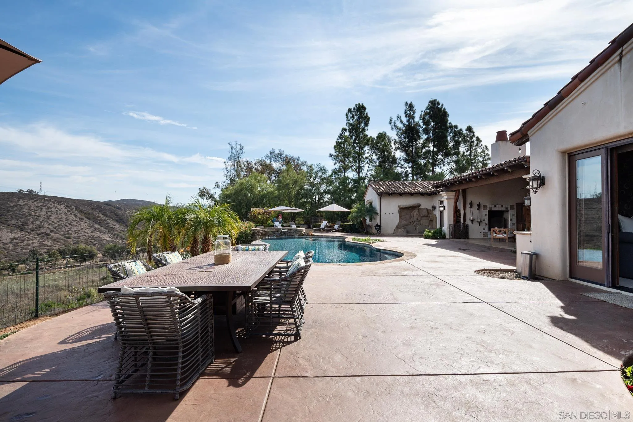 16531 Zumaque Street Rancho Santa Fe, CA 92067 - Photo 34 of 48 a view of a patio with a table and chairs under an umbrella