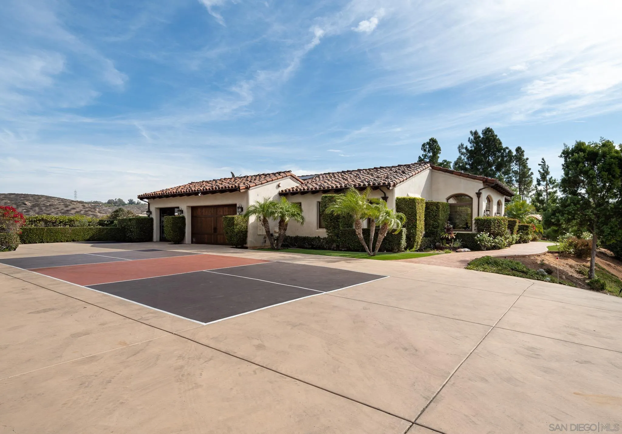 16531 Zumaque Street Rancho Santa Fe, CA 92067 - Photo 36 of 48 a front view of a house with a yard and garage