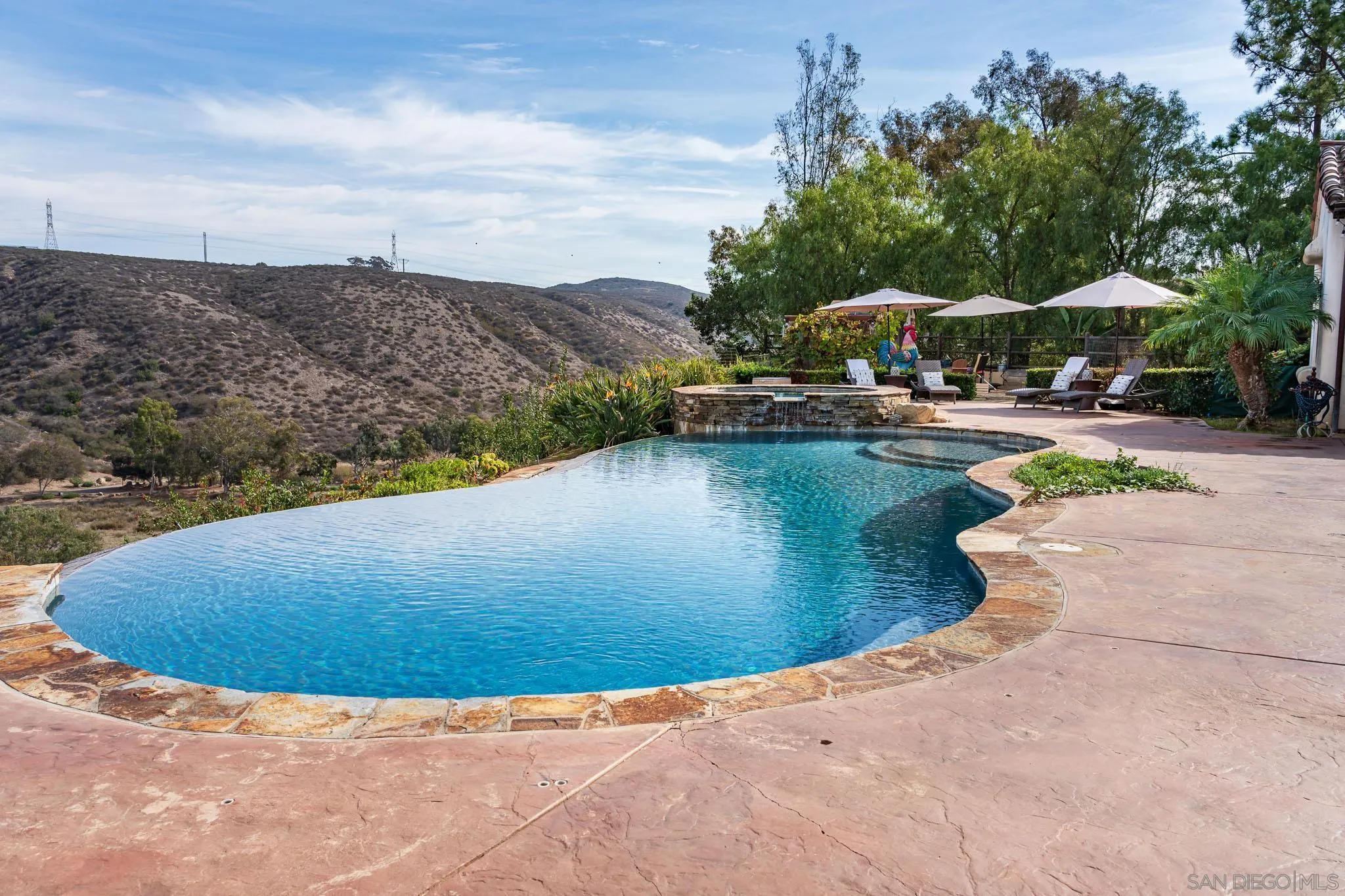 16531 Zumaque Street Rancho Santa Fe, CA 92067 - Photo 39 of 48 a view of a swimming pool with lounge chairs in patio