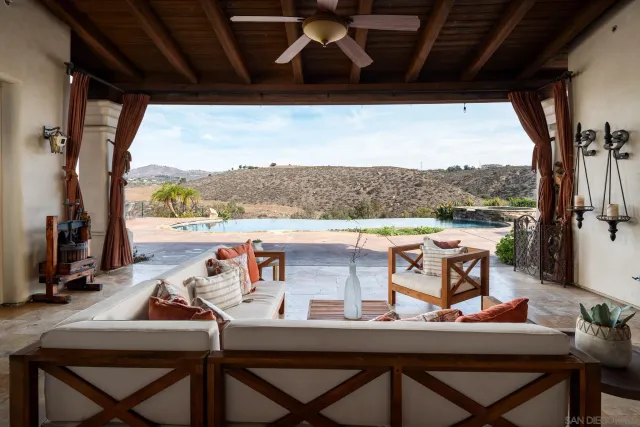 a view of a balcony dining area with furniture