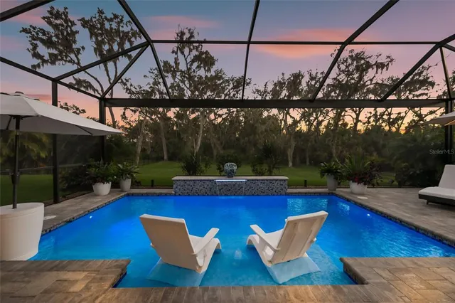 a kitchen with stainless steel appliances granite countertop a sink and a refrigerator