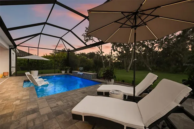 a dining room with furniture potted plants and wooden floor
