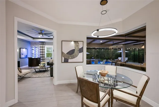 a living room with furniture kitchen view and a chandelier