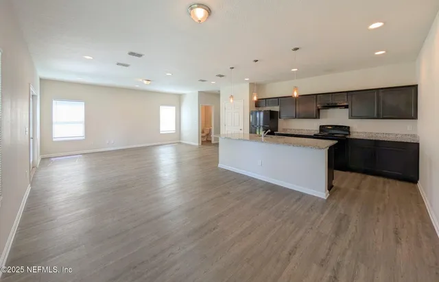 a view of kitchen with sink microwave and stove