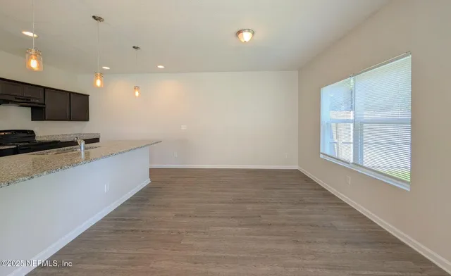 a view of kitchen with microwave and cabinets