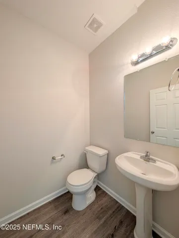 a white toilet sitting next to a bathroom sink