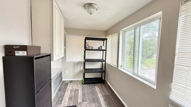 a view of room with window and hallway