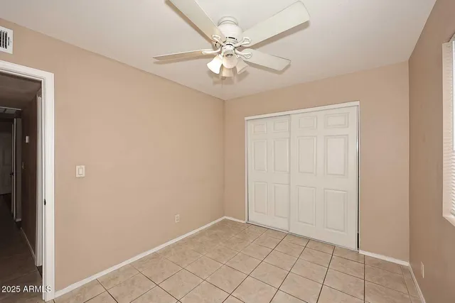 an empty room with fan and fan