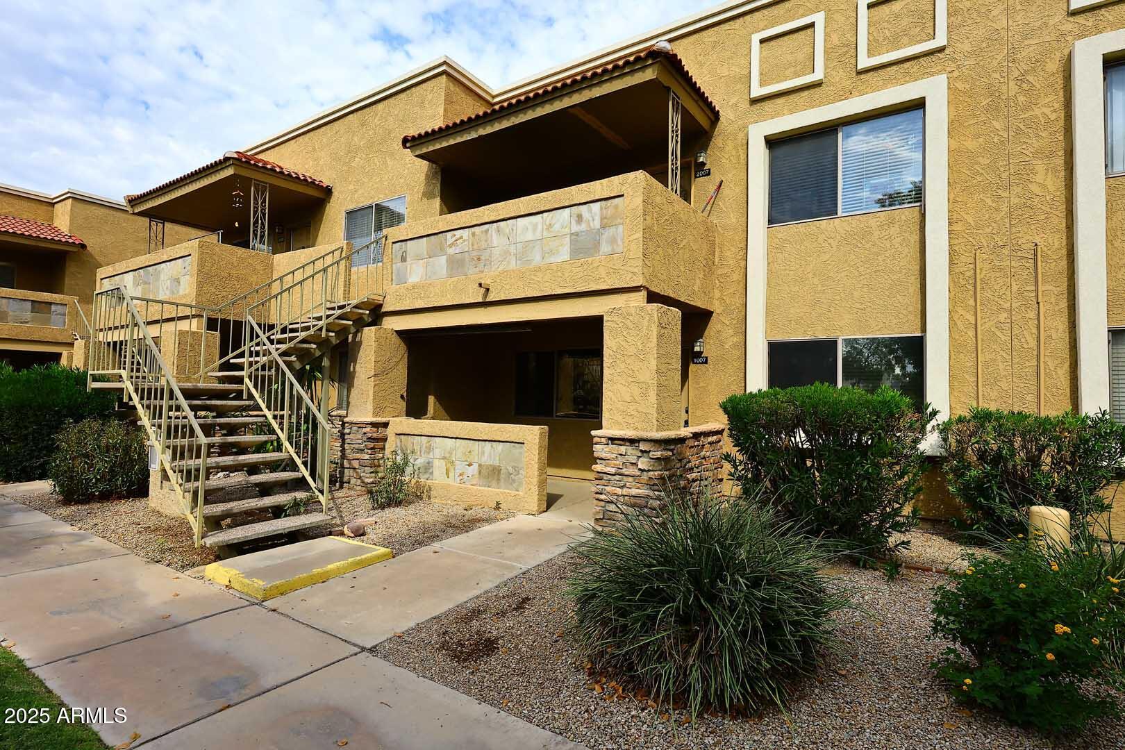 303 North Miller Road, Unit 1007 Scottsdale, AZ 85257 - Photo 2 of 28 a view of a house with backyard and plants