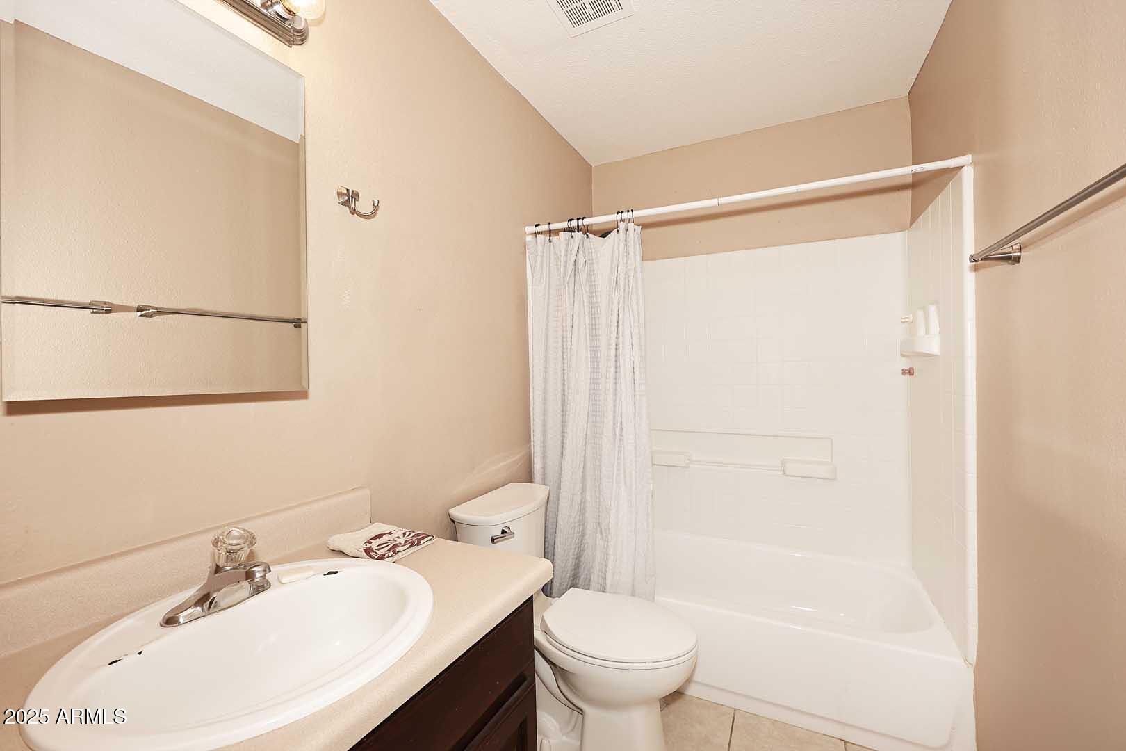 303 North Miller Road, Unit 1007 Scottsdale, AZ 85257 - Photo 23 of 28 a bathroom with a sink toilet and shower
