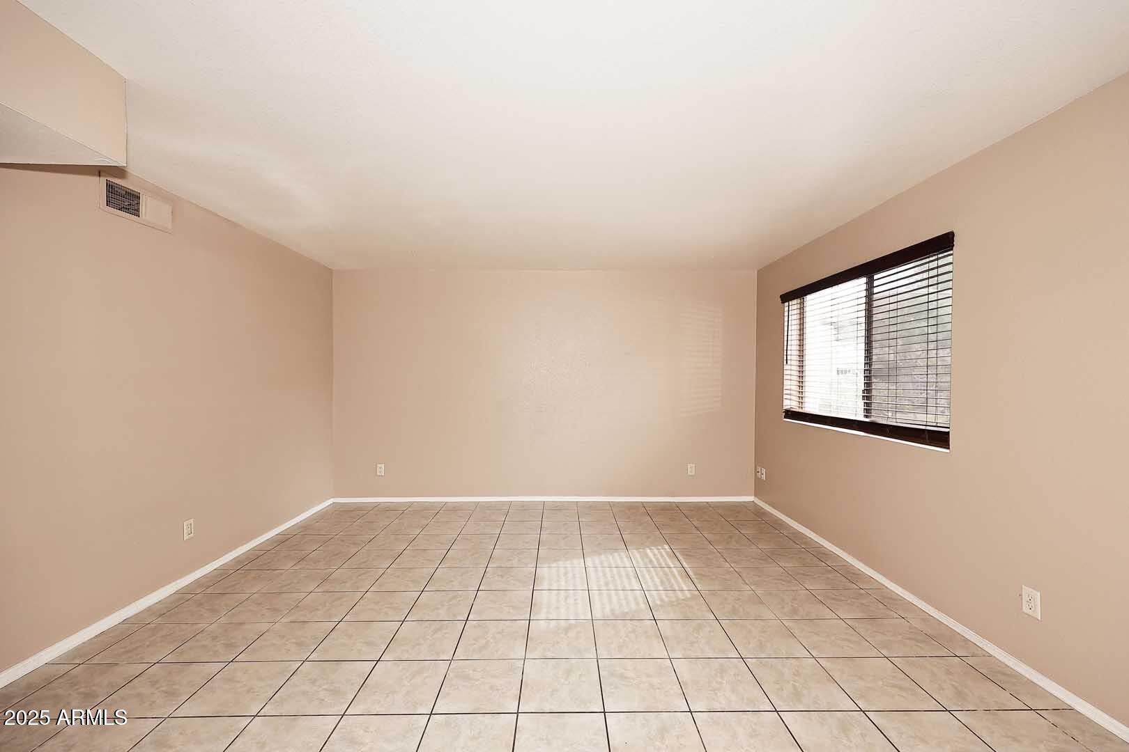 303 North Miller Road, Unit 1007 Scottsdale, AZ 85257 - Photo 5 of 28 a view of an empty room and window
