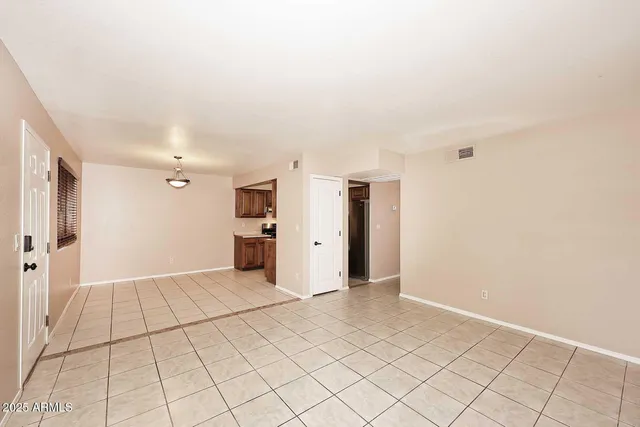 a view of a livingroom with an empty space and a window