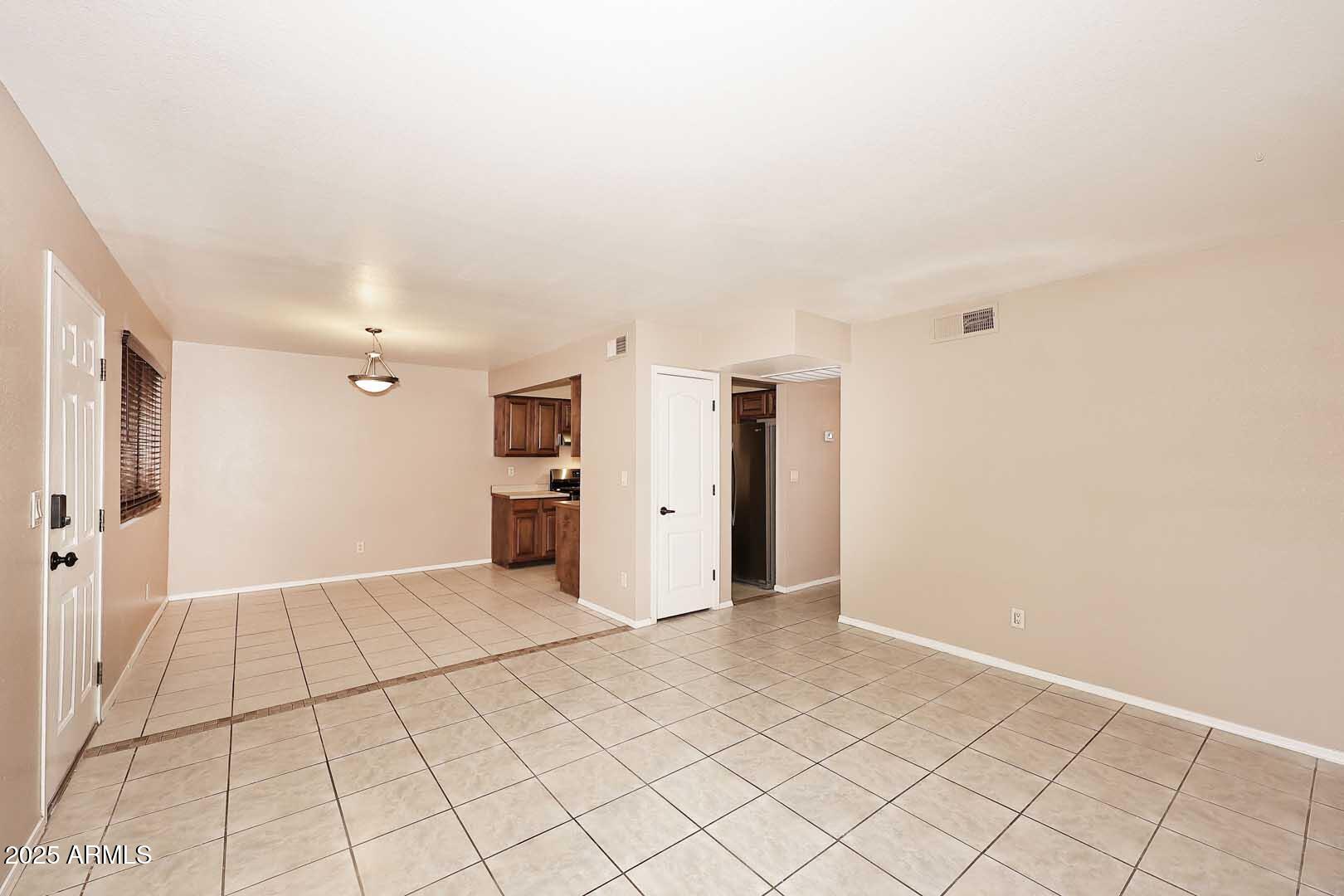 303 North Miller Road, Unit 1007 Scottsdale, AZ 85257 - Photo 8 of 28 a view of a livingroom with an empty space and a window