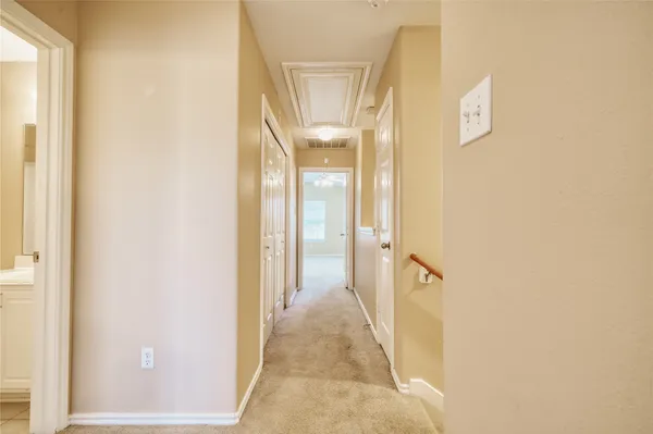 an empty room with a window and a ceiling fan
