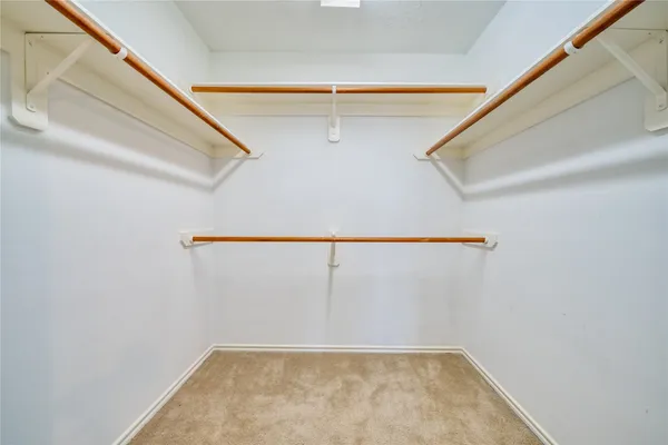 a view of an empty room with a ceiling fan