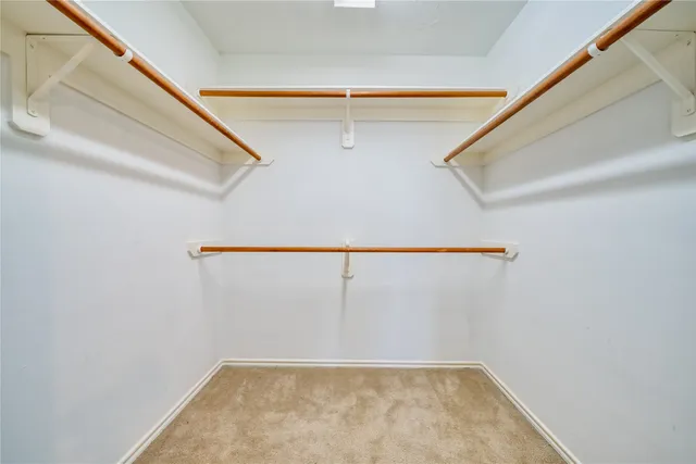 a view of an empty room with a ceiling fan