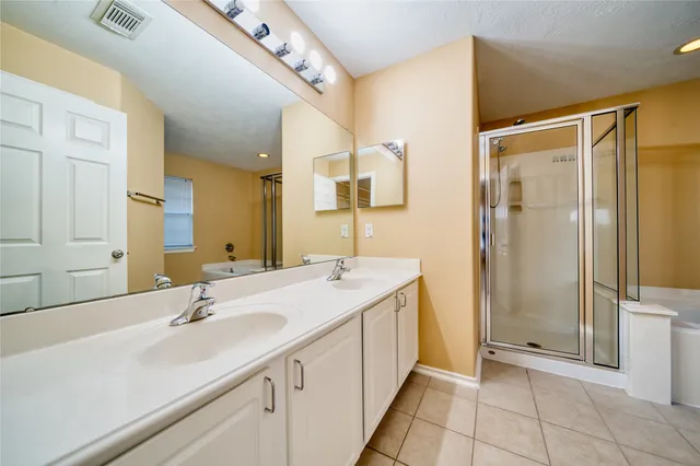 a bathroom with a tub a window and a shower