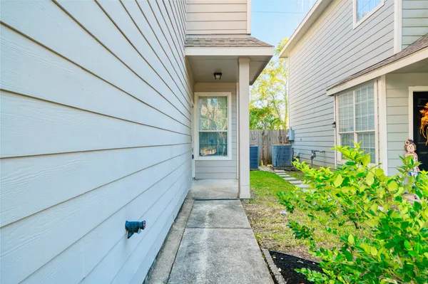 a view of a pathway of a house with a yard