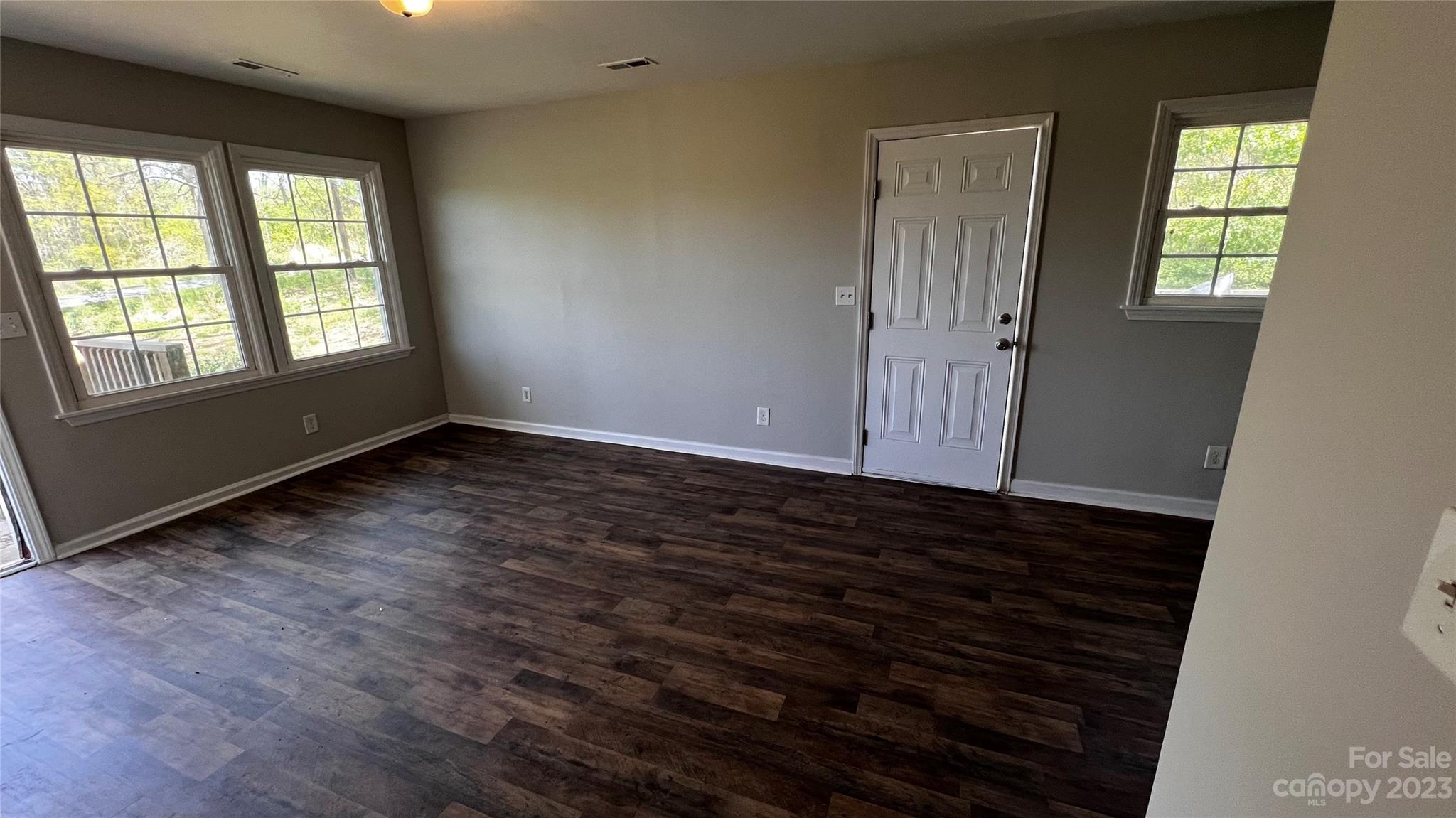 1919 Petty Road Shelby, NC 28150 - Photo 3 of 12 an empty room with wooden floor and windows