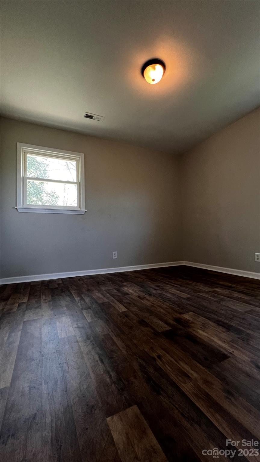 1919 Petty Road Shelby, NC 28150 - Photo 5 of 12 a view of an empty room with wooden floor and a window