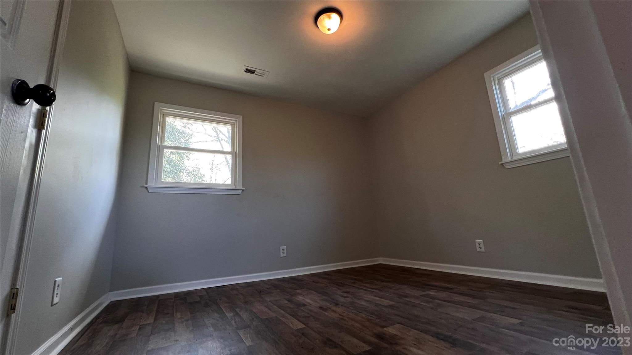 1919 Petty Road Shelby, NC 28150 - Photo 6 of 12 an empty room with wooden floor and windows