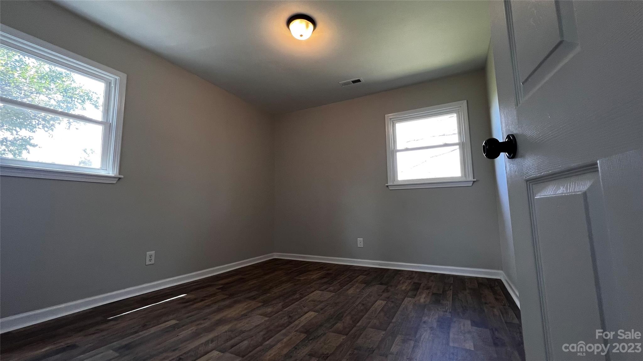 1919 Petty Road Shelby, NC 28150 - Photo 7 of 12 an empty room with wooden floor and windows