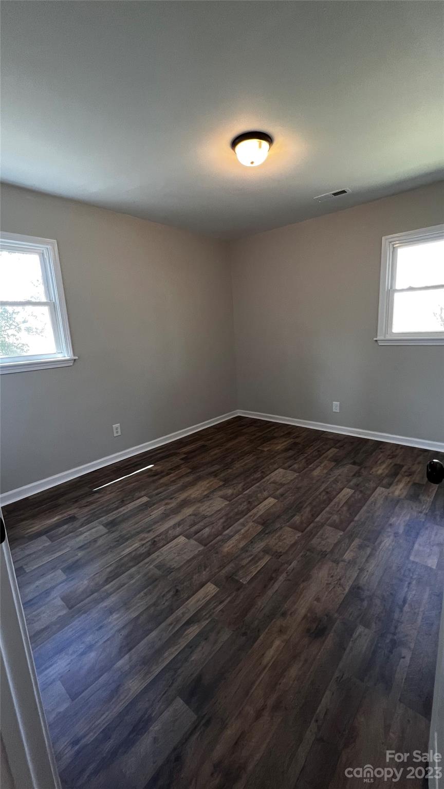 1919 Petty Road Shelby, NC 28150 - Photo 8 of 12 an empty room with wooden floor and windows