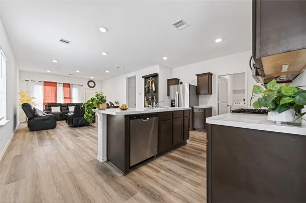 a large kitchen with stainless steel appliances kitchen island granite countertop a large counter top stainless steel appliances and cabinets