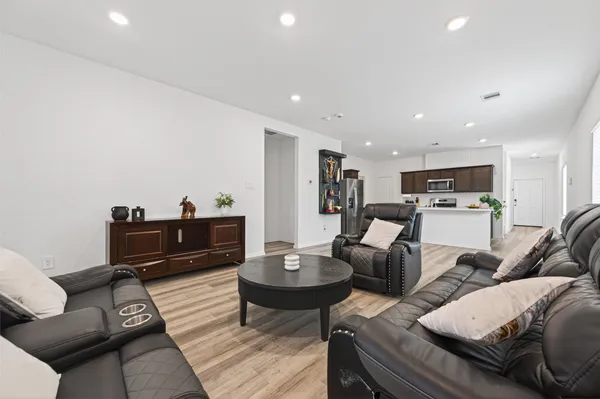 a living room with furniture a table and chairs