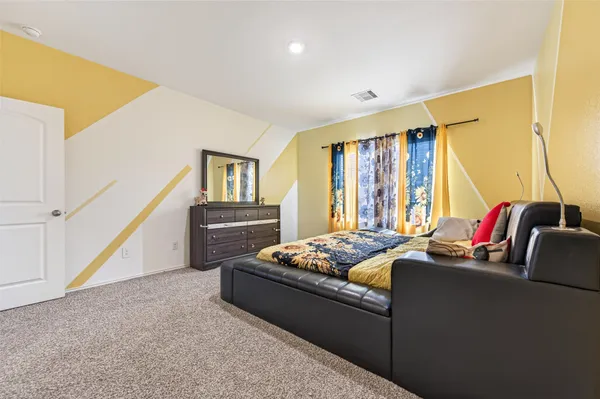 a bedroom with furniture and a window