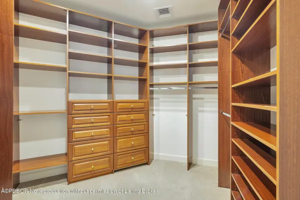 a view of closet area with empty racks