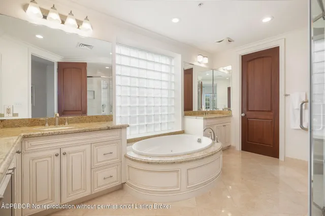 a bathroom with a double vanity sink a mirror a bathtub and shower