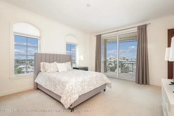 a bedroom with a large bed and a large window