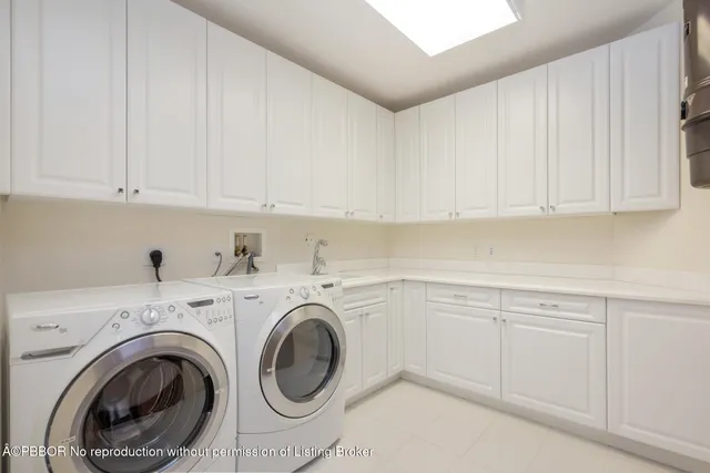 a utility room with sink dryer and washer