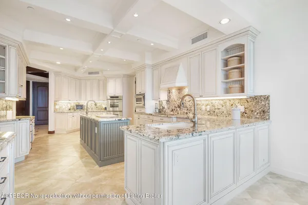 a kitchen with granite countertop a sink cabinets and wooden floor