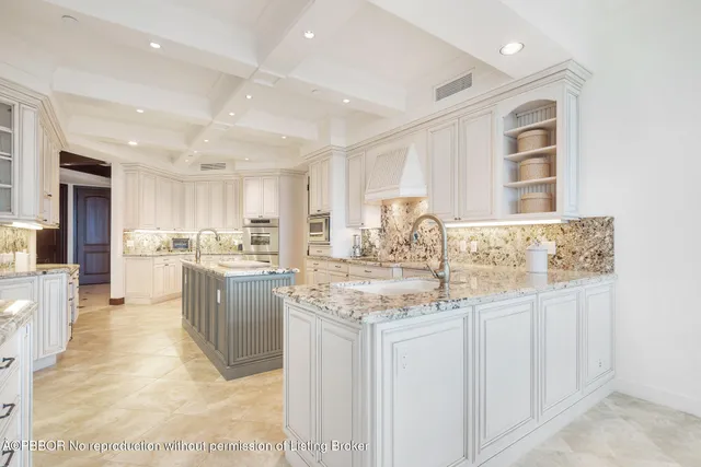 a kitchen with granite countertop a sink cabinets and wooden floor