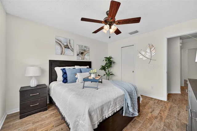a bedroom with a bed and wooden floor