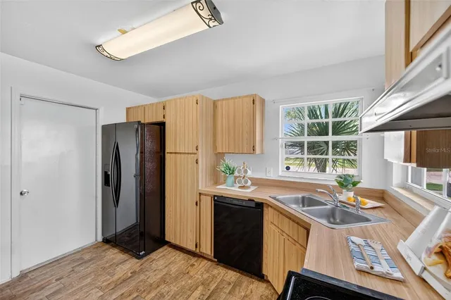 a kitchen with a sink appliances and cabinets