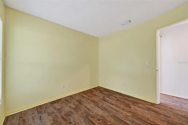 a view of a room with wooden floor