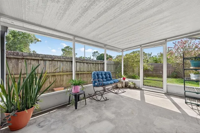 a building outdoor space with patio furniture and garden