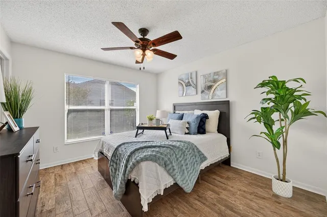 a bedroom with bed and a potted plant