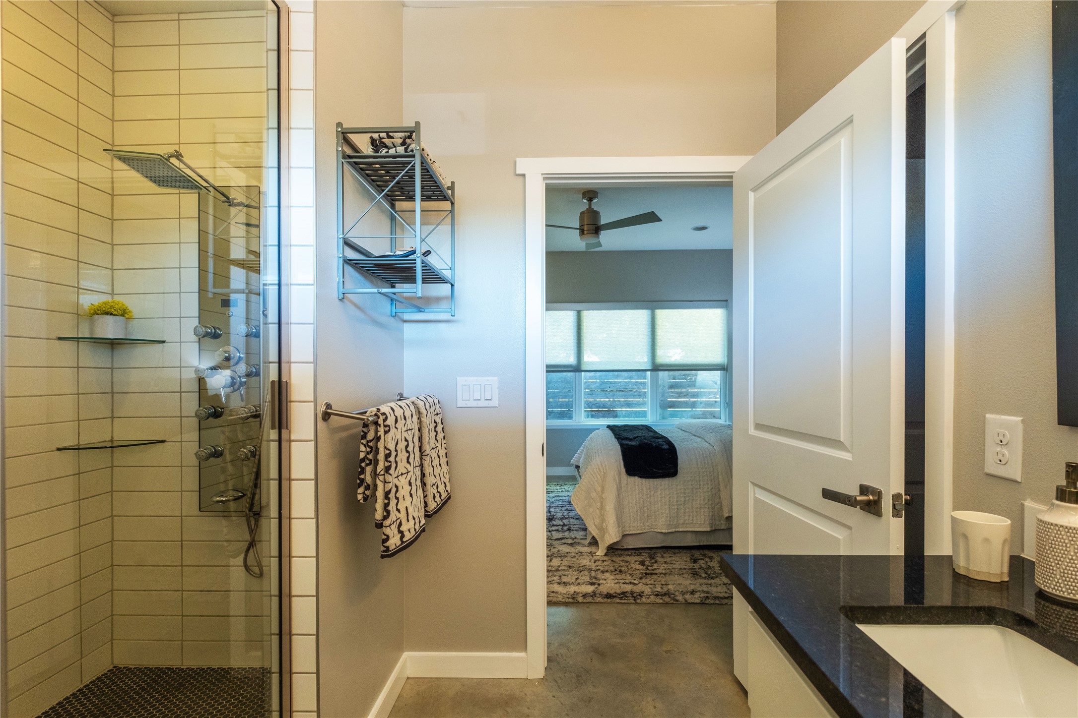 7601 Bethune Avenue, Unit B Austin, TX 78752 - Photo 16 of 39 Ensuite bathroom featuring vanity, a stall shower, a ceiling fan, and concrete floors