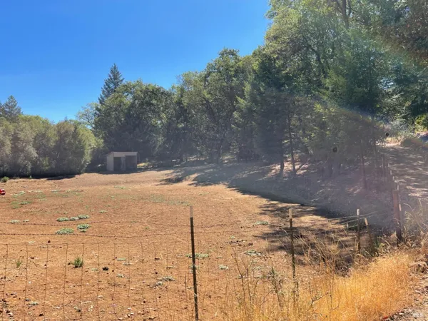 a view of a mountain range with trees in the background